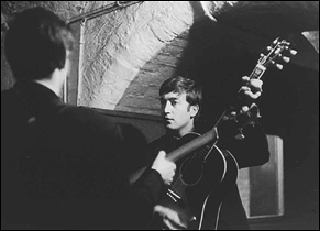A moody photo of the early days of The Beatles at the Cavern Club in Liverpool, England. Pictured: John Lennon.